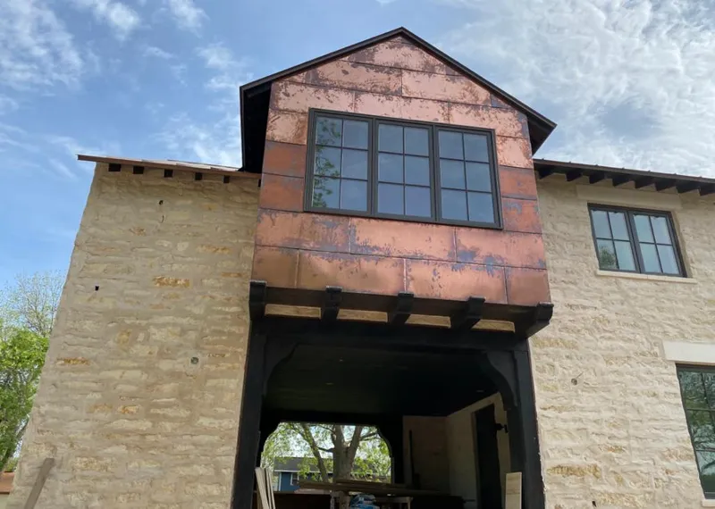 Copper metal panel facade on a stone building for Roof Repair in Nephi